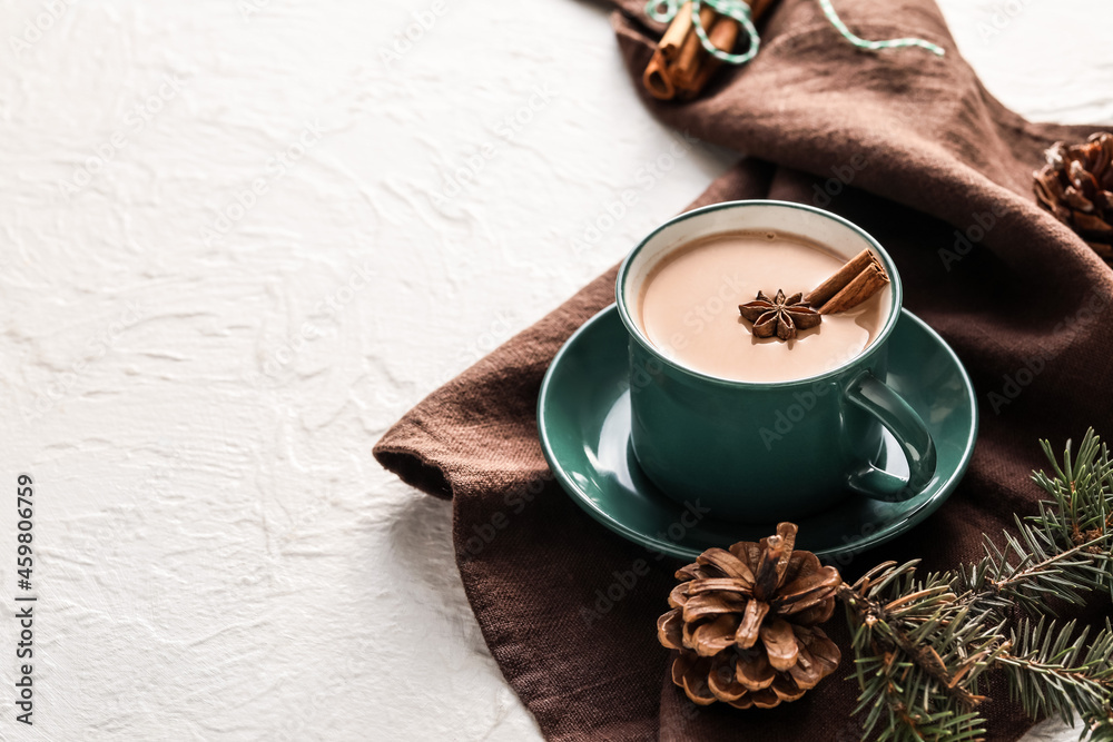 Composition with cup of hot cocoa drink and pine cones on light background