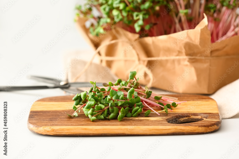 Wooden board with fresh organic micro green on table, closeup