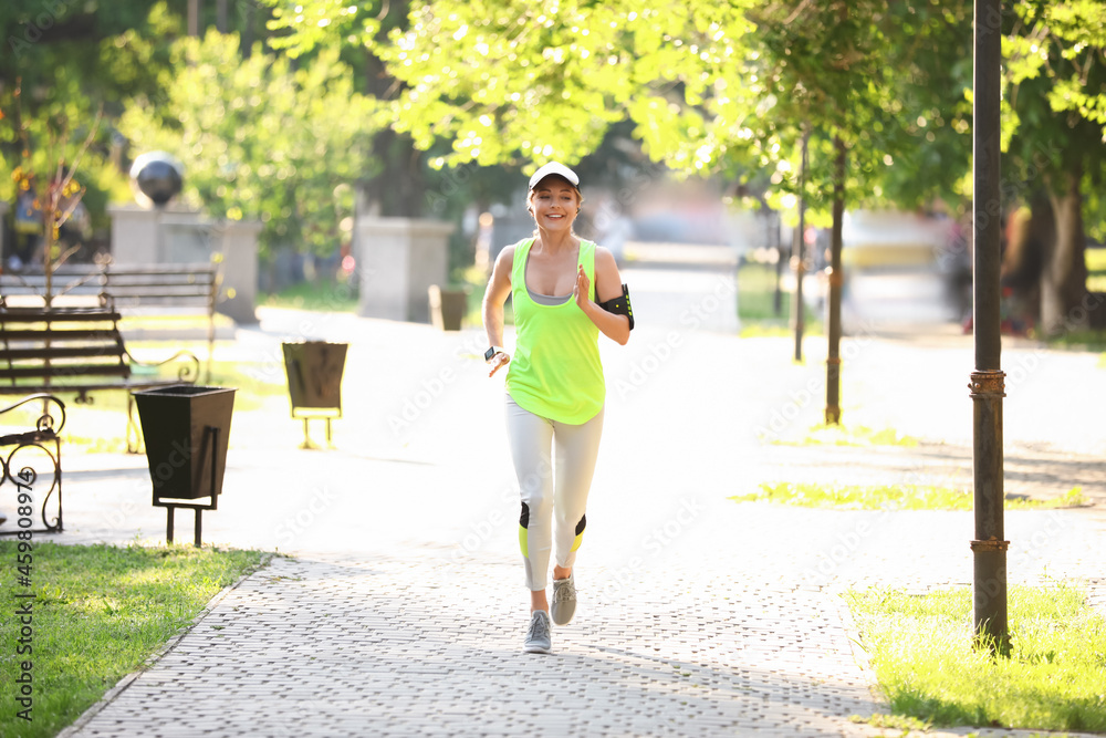 Sporty mature woman running outdoors