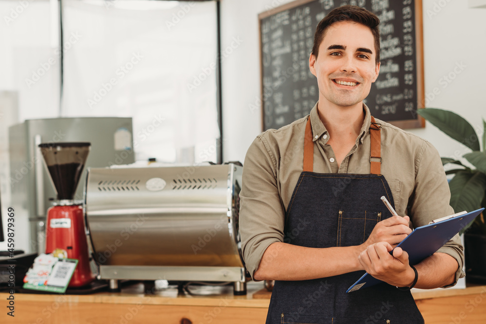 Portrait of a handsome and confident cafe owner standing at the door. looking at camera smiling.