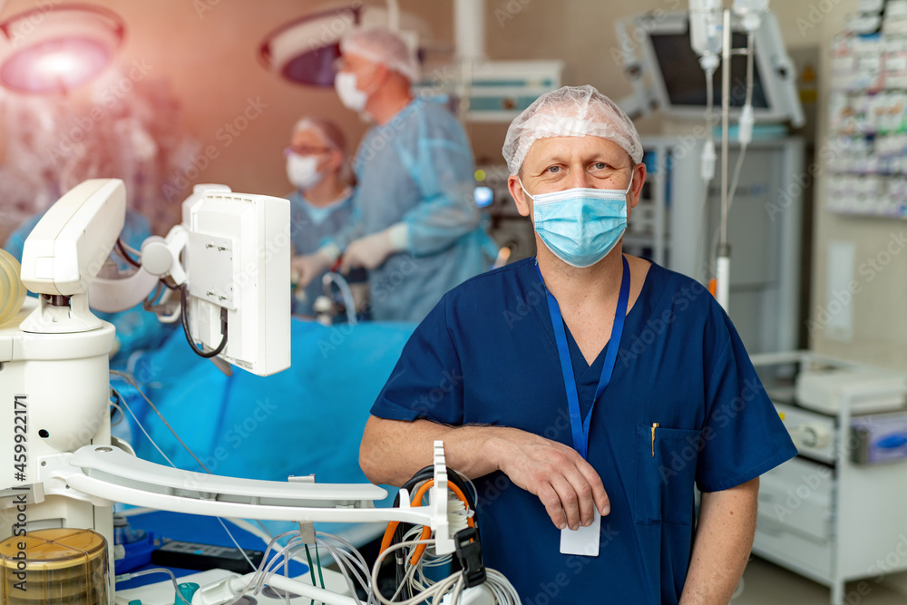 Handsome surgery doctor in protective mask. Professional medical emergency specialist.