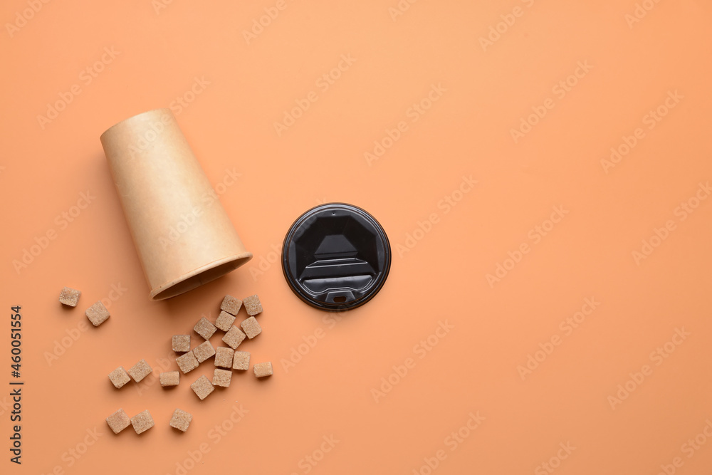 Cup of coffee and sugar on color background