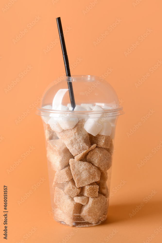 Cup with sweet sugar on color background