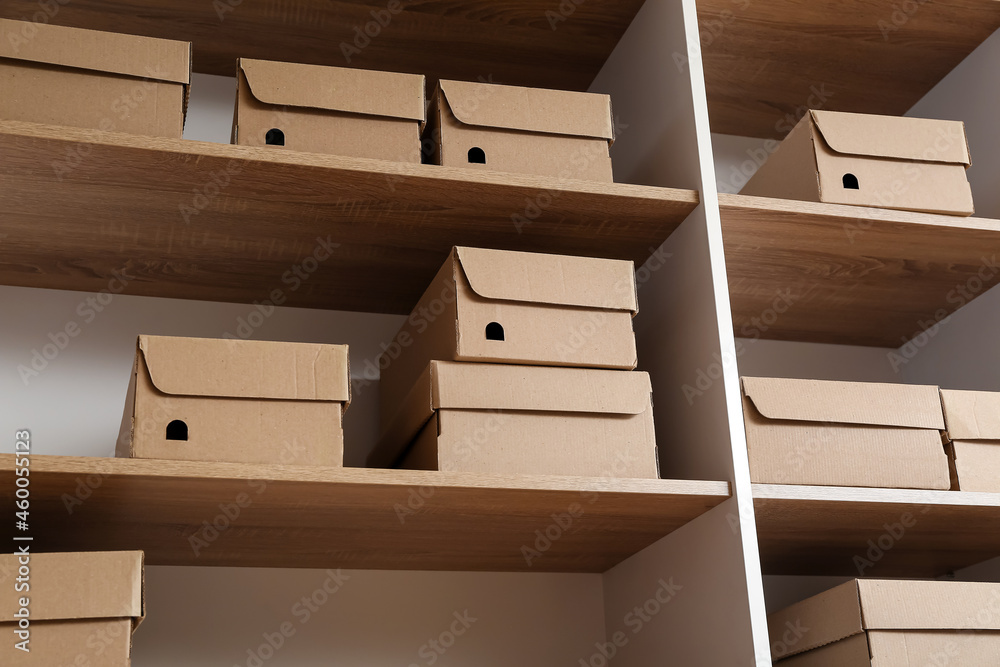 Many cardboard boxes on shelves in wardrobe