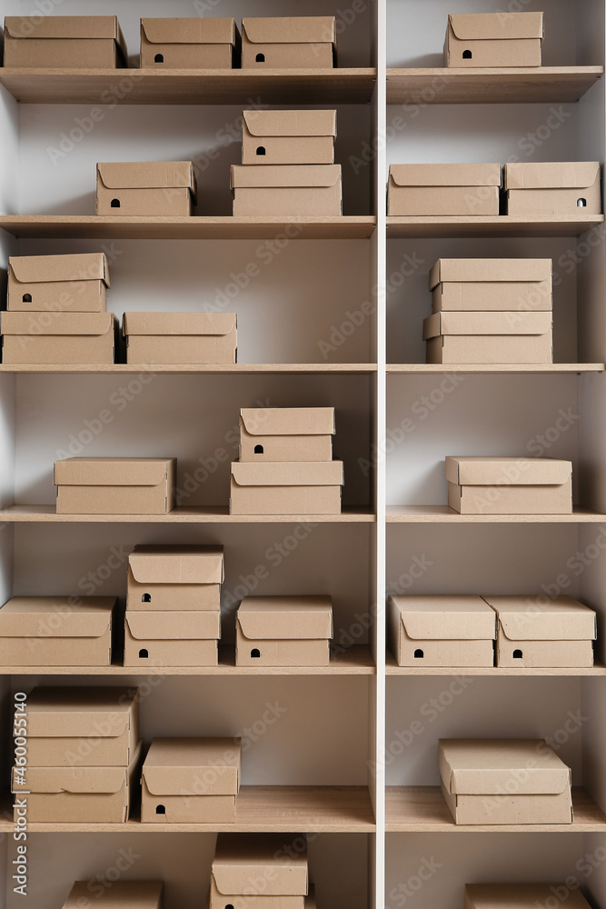 Many cardboard boxes on shelves in wardrobe