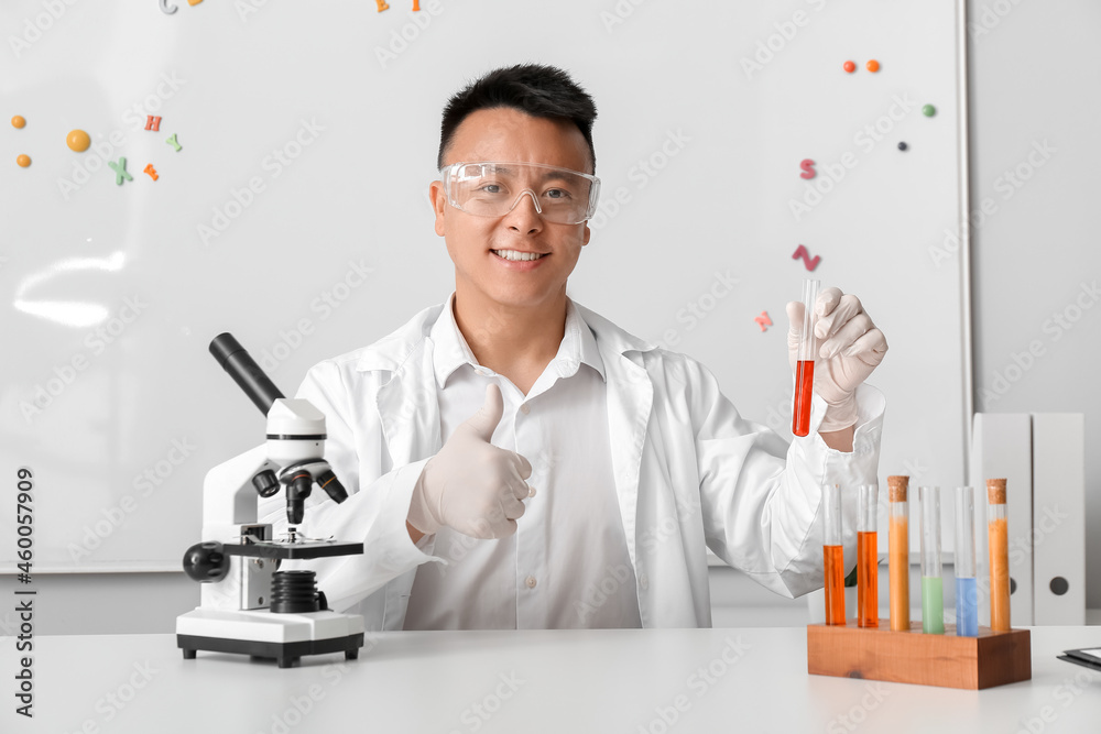 Asian teacher conducting chemistry lesson