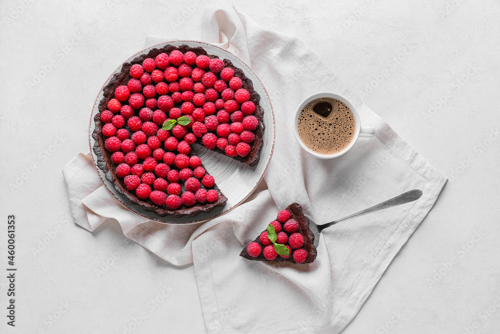 Spatula with piece of tasty raspberry pie and cup of coffee on light background