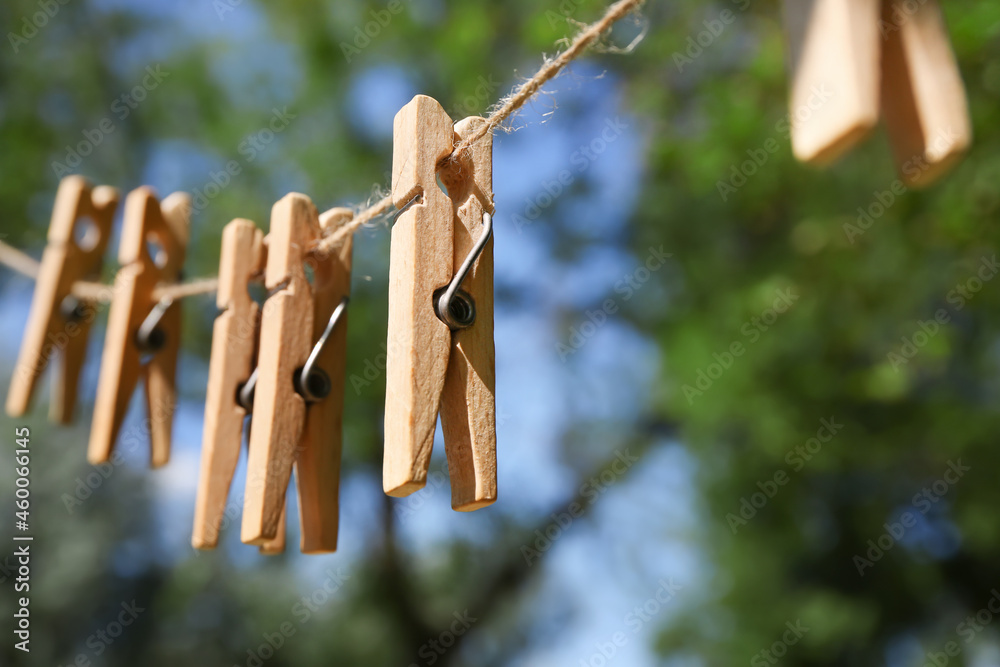 Clothespins hanging on laundry line outdoors