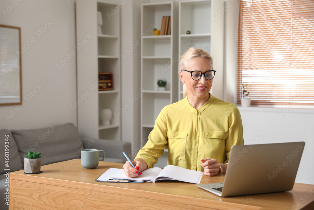 Mature woman working in office