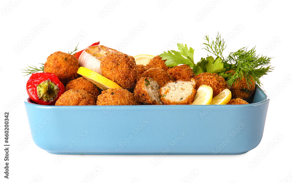 Baking dish with tasty cod cutlets and spices on white background