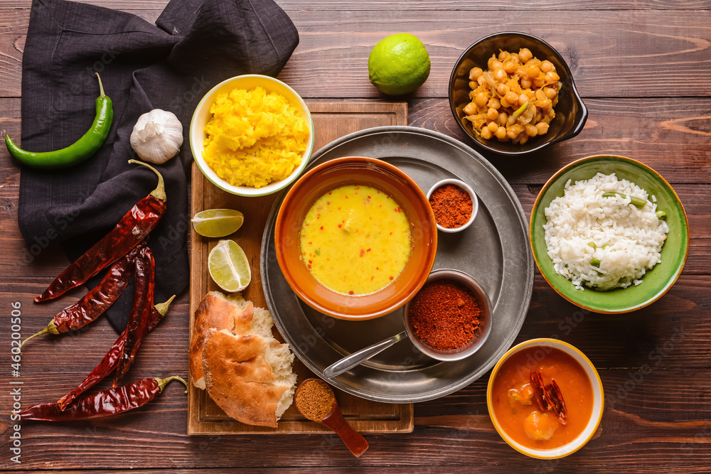 Traditional Indian food and spices on wooden background