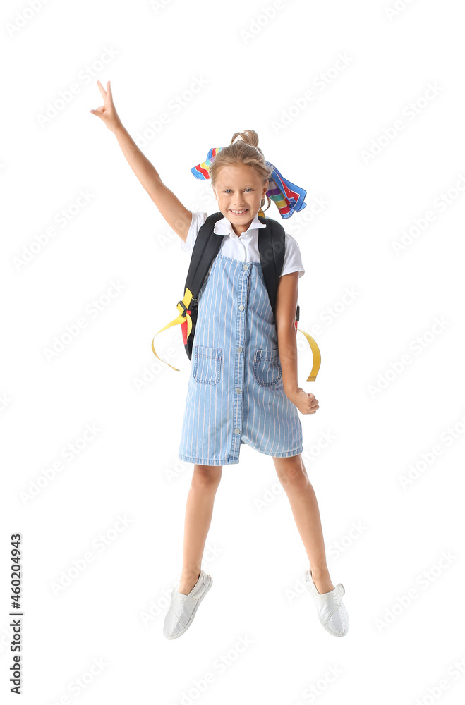 Jumping little schoolgirl on white background