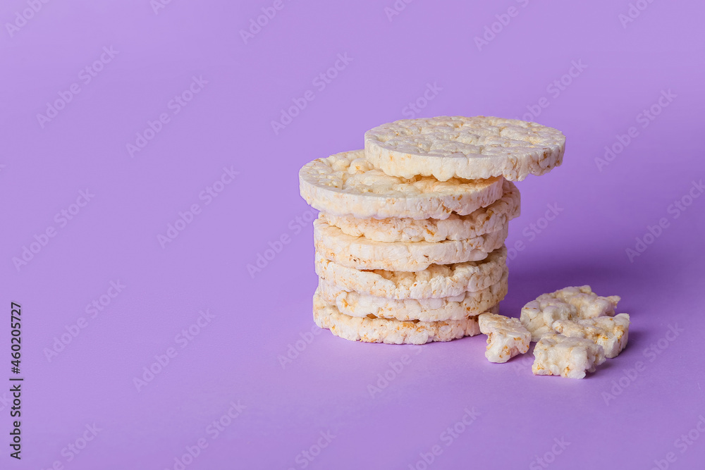 Puffed corn crackers on purple background