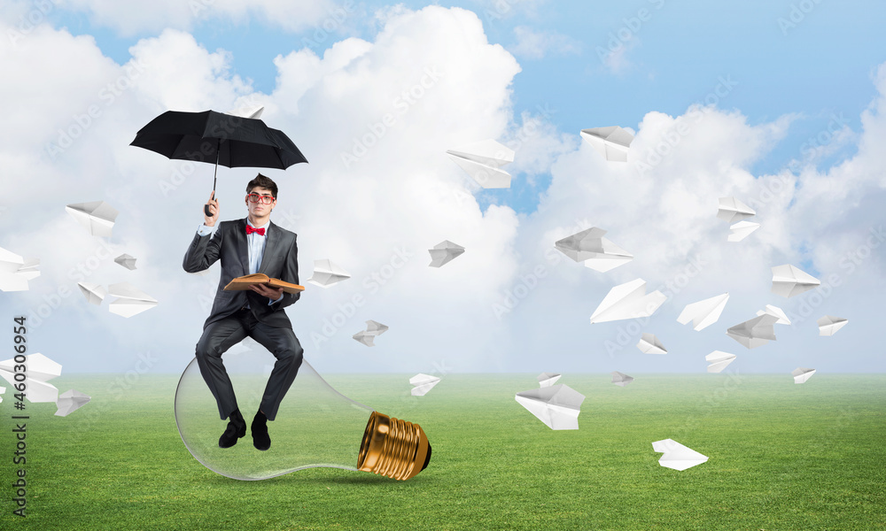 young businessman with an umbrella and a book