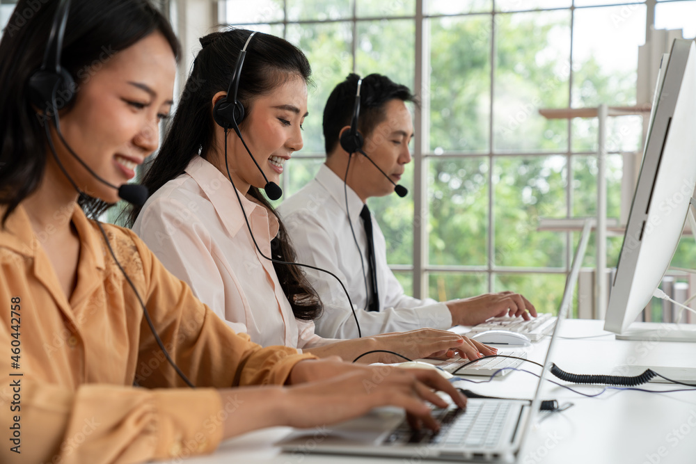 Business people wearing headset working actively in office . Call center, telemarketing, customer su