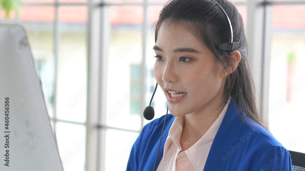 Businesswoman wearing headset working actively in office . Call center, telemarketing, customer supp