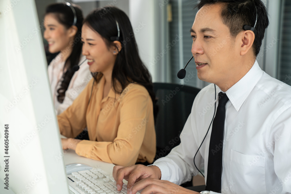 Business people wearing headset working actively in office . Call center, telemarketing, customer su