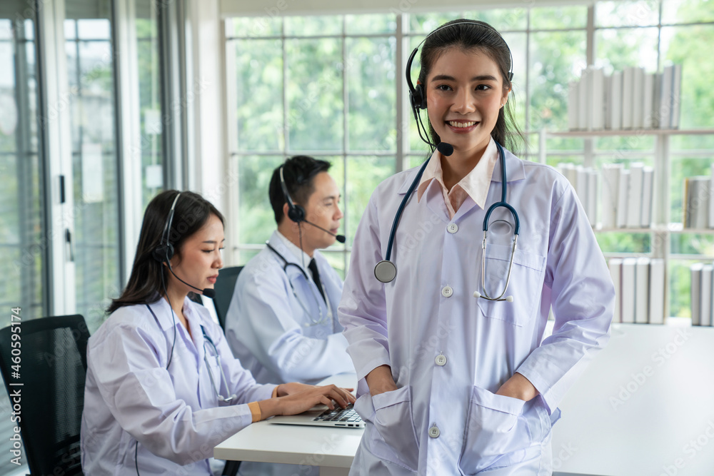 Doctor team wearing headset talking actively on video call in hospital clinic . Concept of telehealt