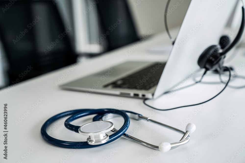 Headset and doctor equipment at clinic ready for actively support for patient by online video call .