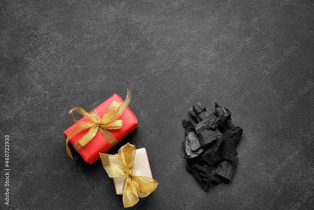 Coal with gift boxes on dark background