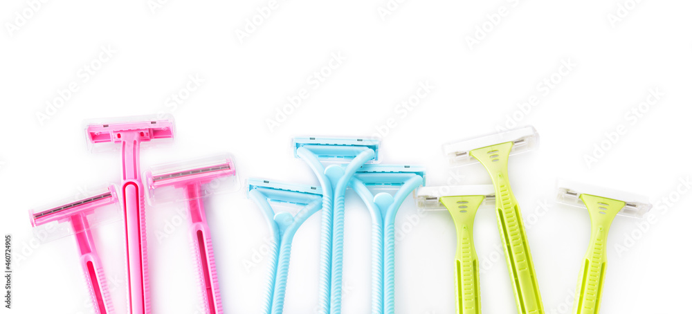 Many colorful razors on white background, closeup