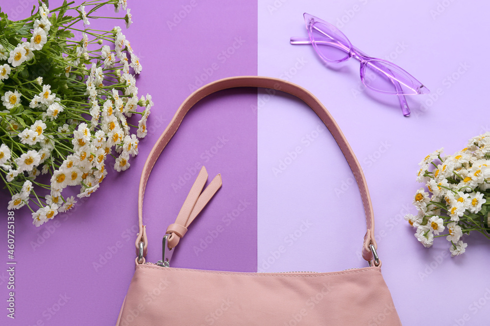 Stylish female accessories, sunglasses and beautiful flowers on color background