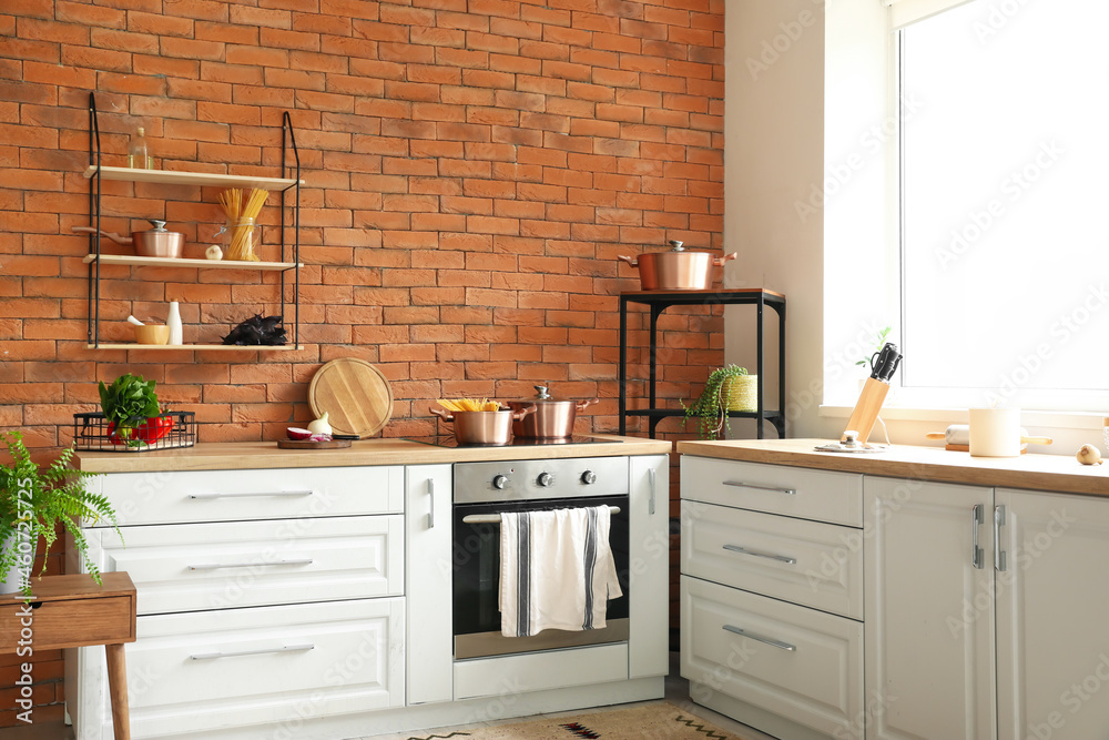 Interior of stylish kitchen with modern cookware and food