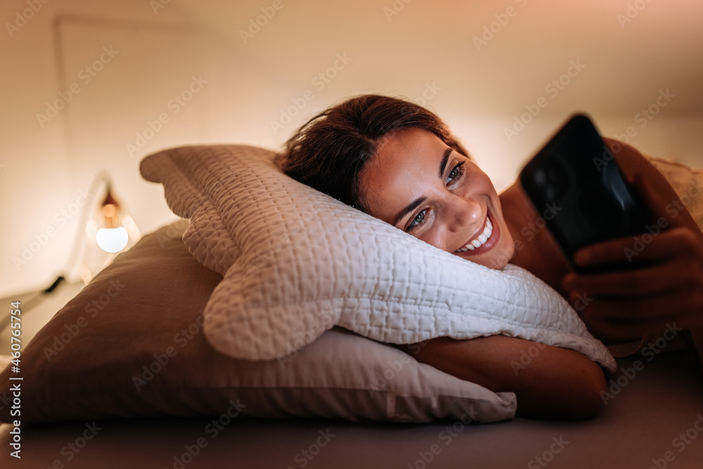 Adult woman, cleaning up her phone before bed.