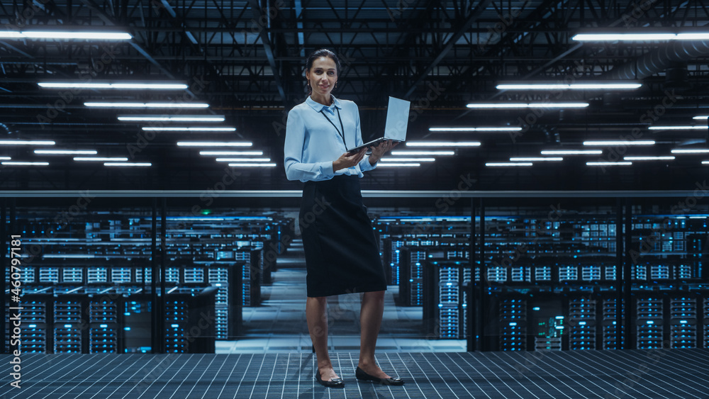 Portrait of a Female Data Center Engineer Using Laptop Computer. Server Room Specialist Facility wit