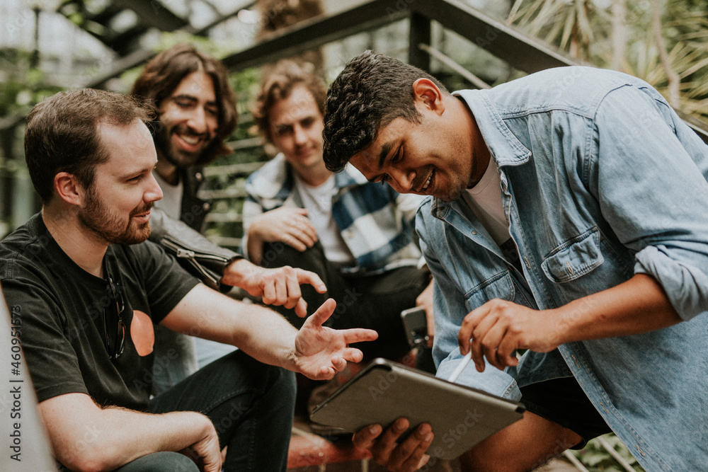 Happy friends chatting together, stock image in botanical garden