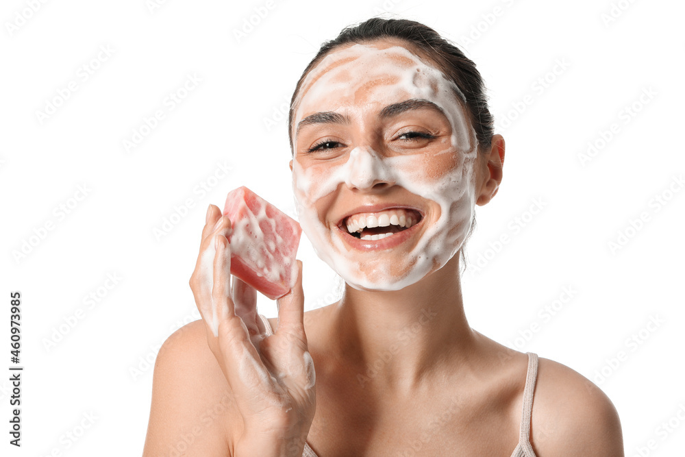 Beautiful young woman with soap on white background