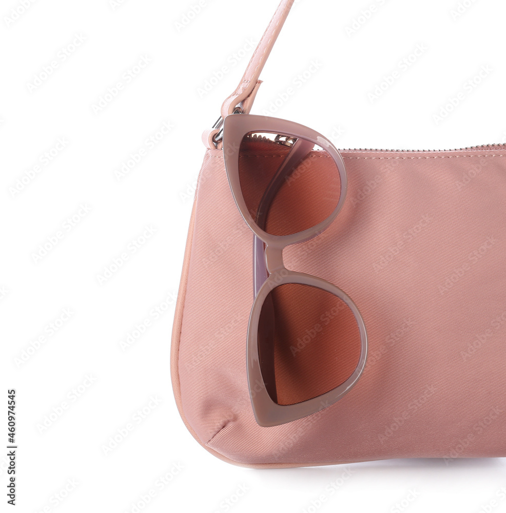 Stylish female handbag and sunglasses on white background