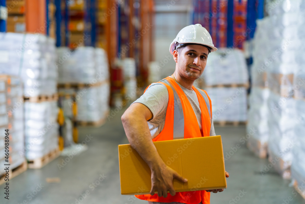 Portrait of a happy middle-aged Caucasian warehouse worker standing in large warehouse distribution 