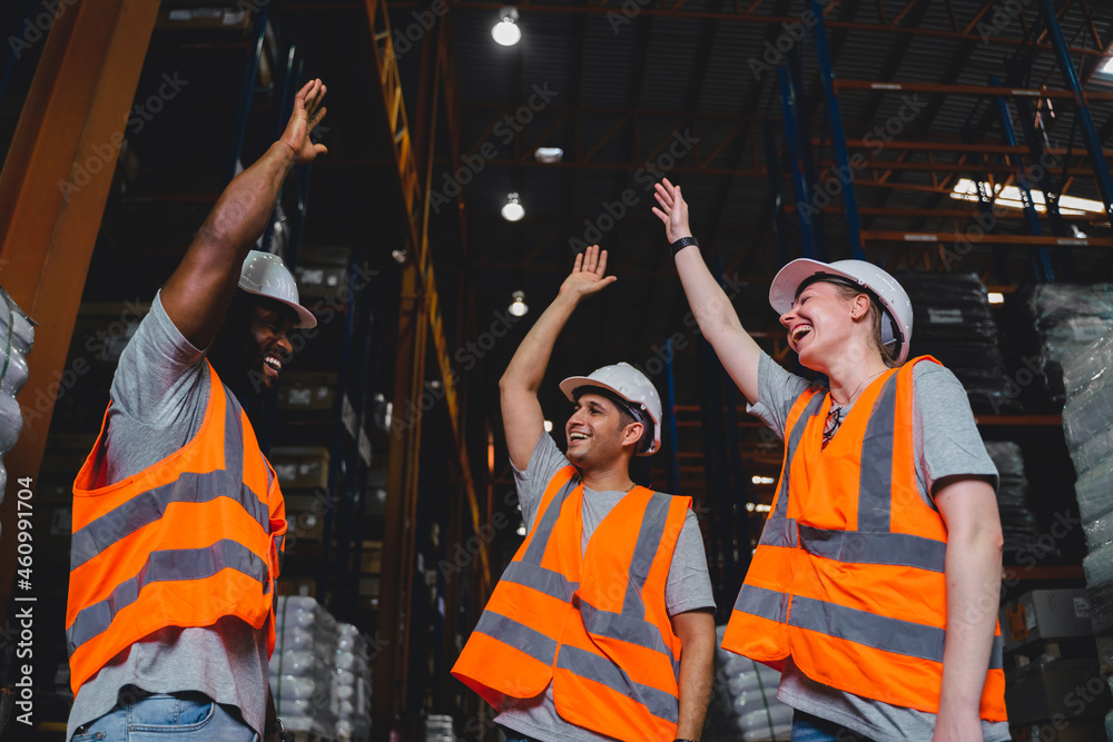 A Group of Diversity warehouse workers giving hand for high-five after success the project and celeb