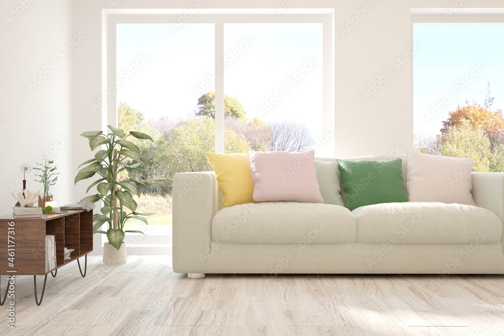 Stylish room in white color with sofa and autumn landscape in window. Scandinavian interior design. 