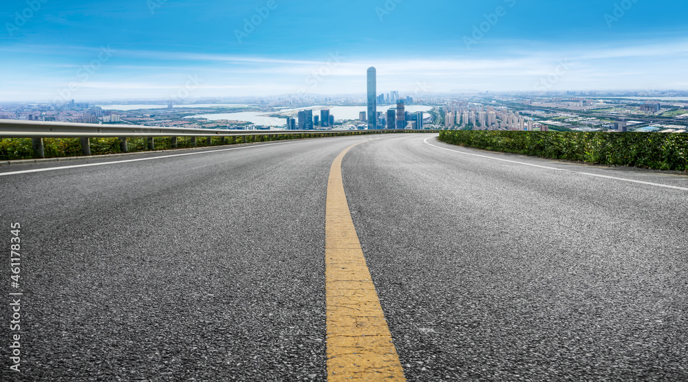 空旷的柏油路、城市天际线和建筑景观，中国。