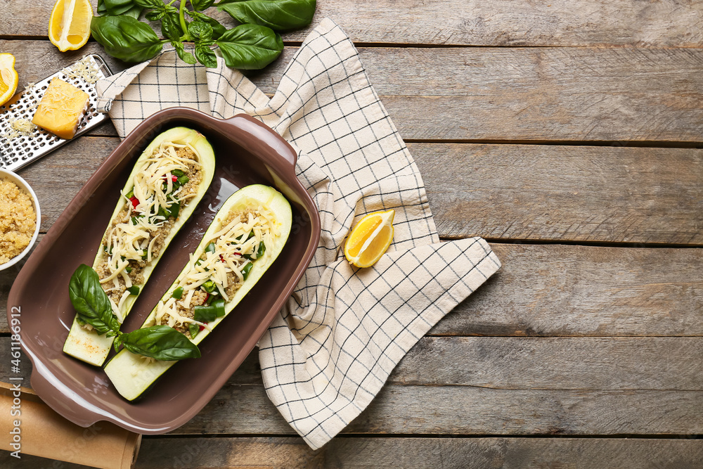 Composition with quinoa stuffed zucchini boats on wooden background