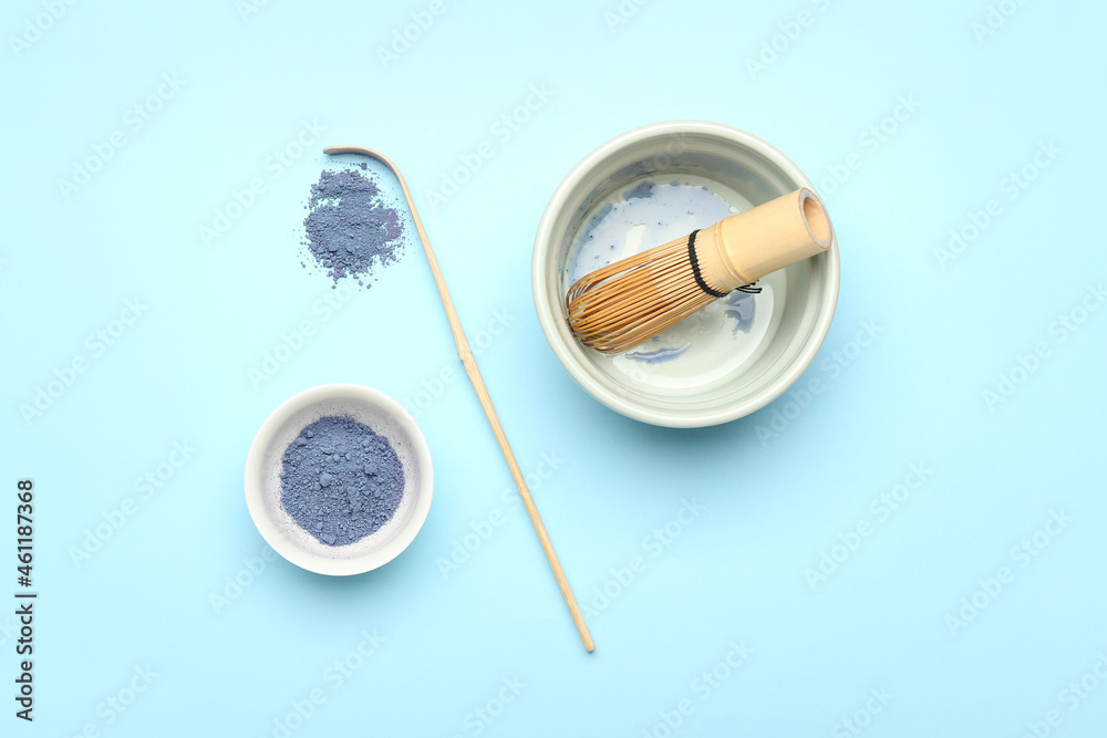 Composition with powdered blue matcha tea on color background