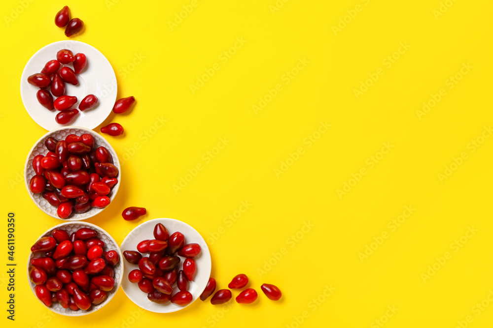 Composition with fresh dogwood berries on color background