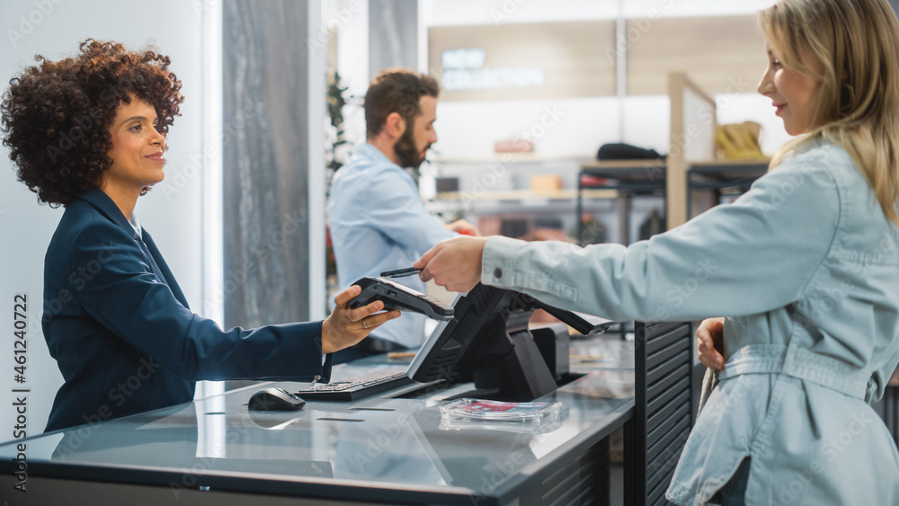 Clothing Store Checkout Cashier Counter: Woman and Male Retail Sales Managers Accept NFC Smartphone 