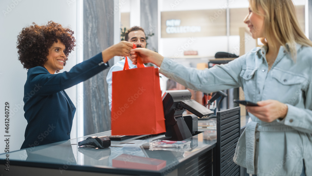 服装店收银台：男女零售经理接受NFC智能手机