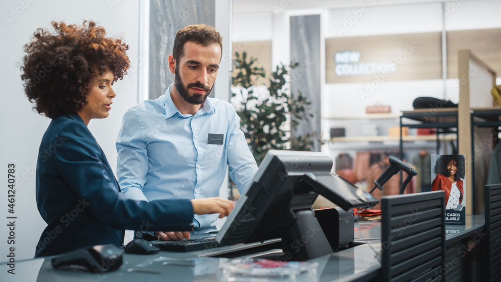 Clothing Store Checkout Cashier Counter: Female Retail Sales Manager Explaining to New Male Assistan