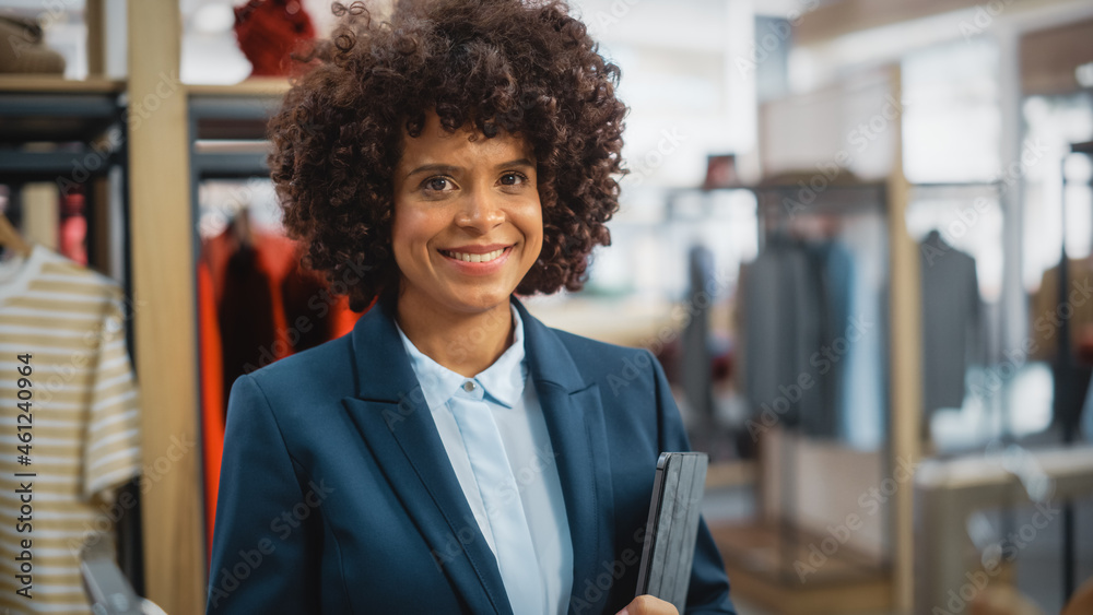 Portrait of a Happy Black Female with Stylish Afro Hair Smiling and Posing for Camera at Clothing St