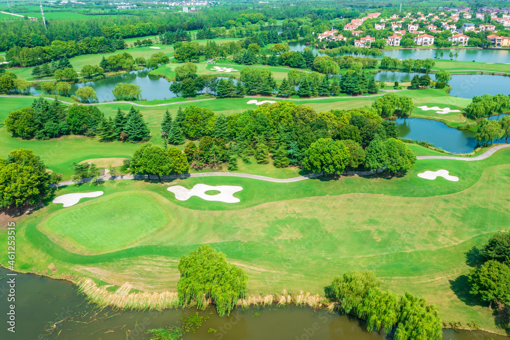 Aerial view of green lawn and forest on golf course.Green golf course scenery.