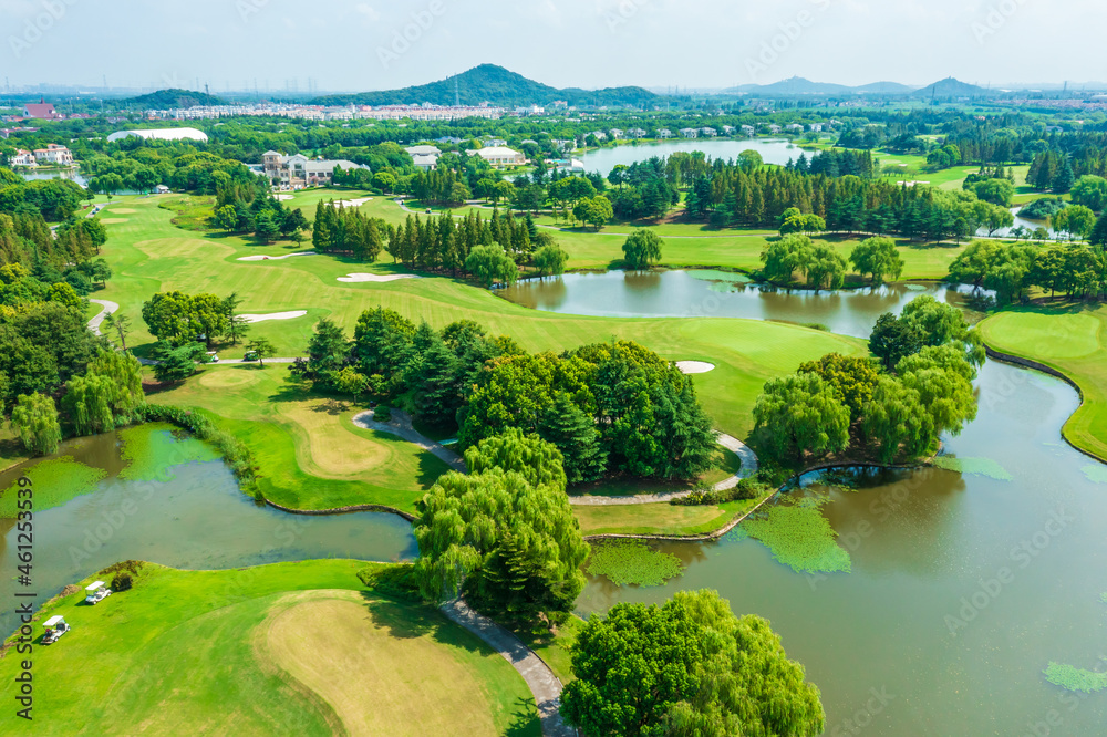 Aerial view of green lawn and forest on golf course.Green golf course scenery.