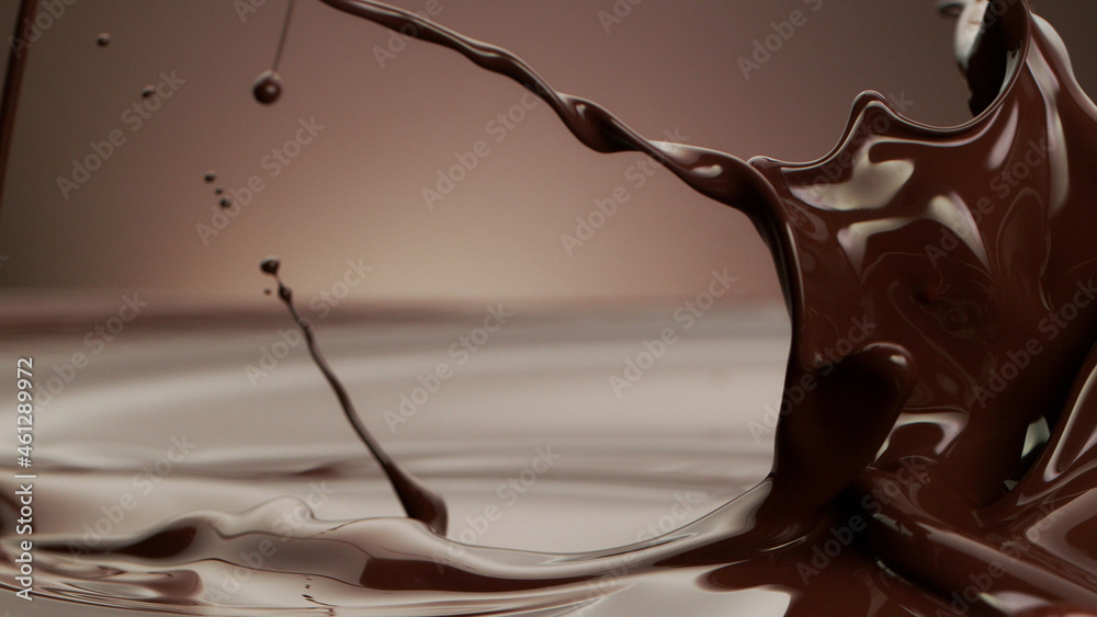 Macro photo of premium dark chocolate splashing.