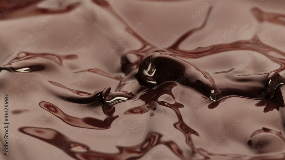 Macro photo of premium dark chocolate splashing.