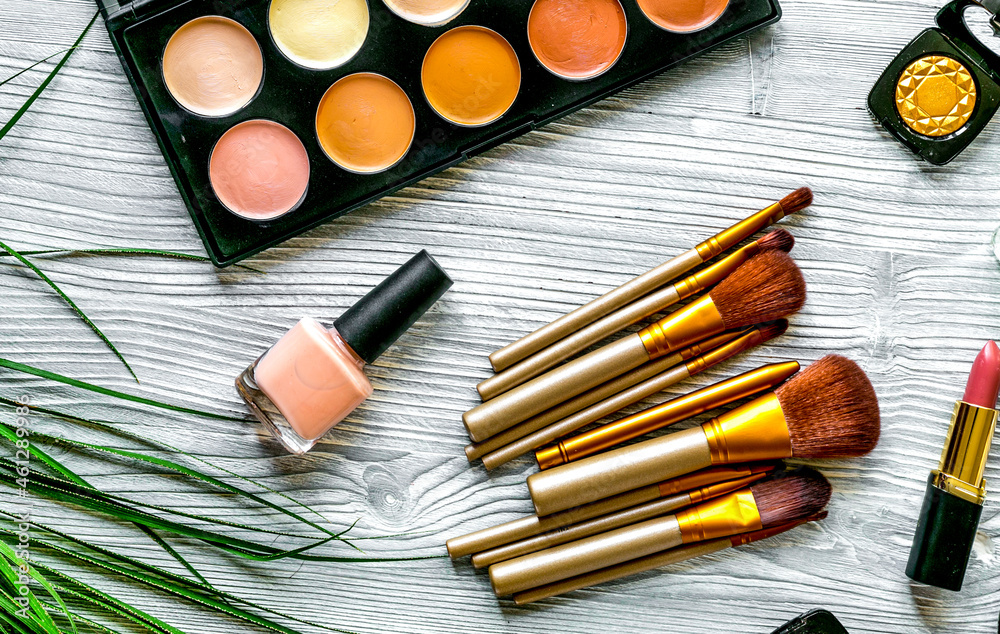 cosmetic set with eye shadow on woman table background top view