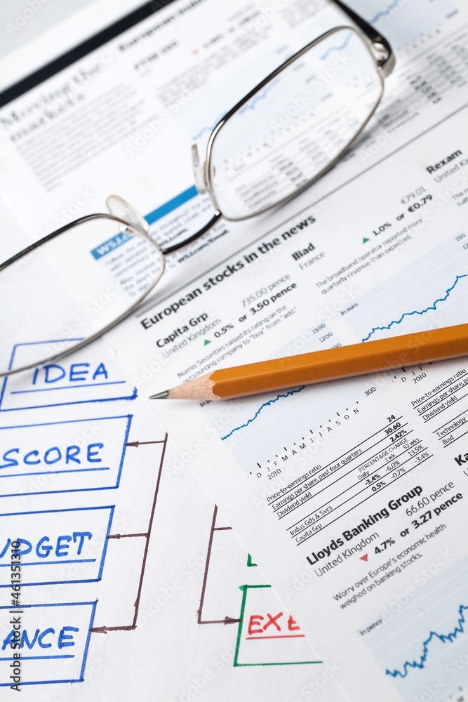 Glasses and Pencil on Business Sheets Close-Up