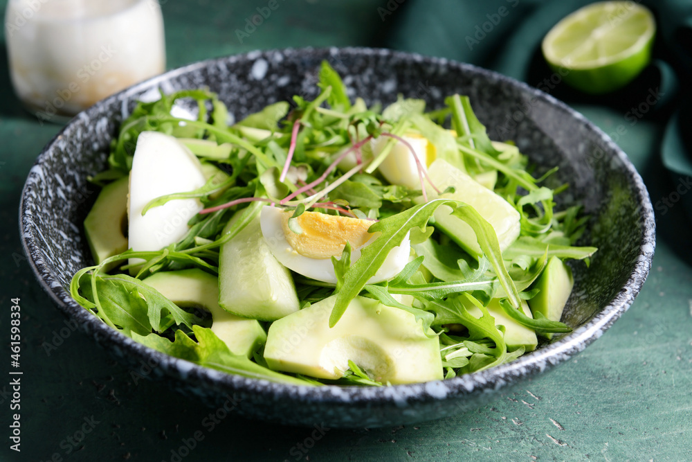 Plate with healthy salad on color background